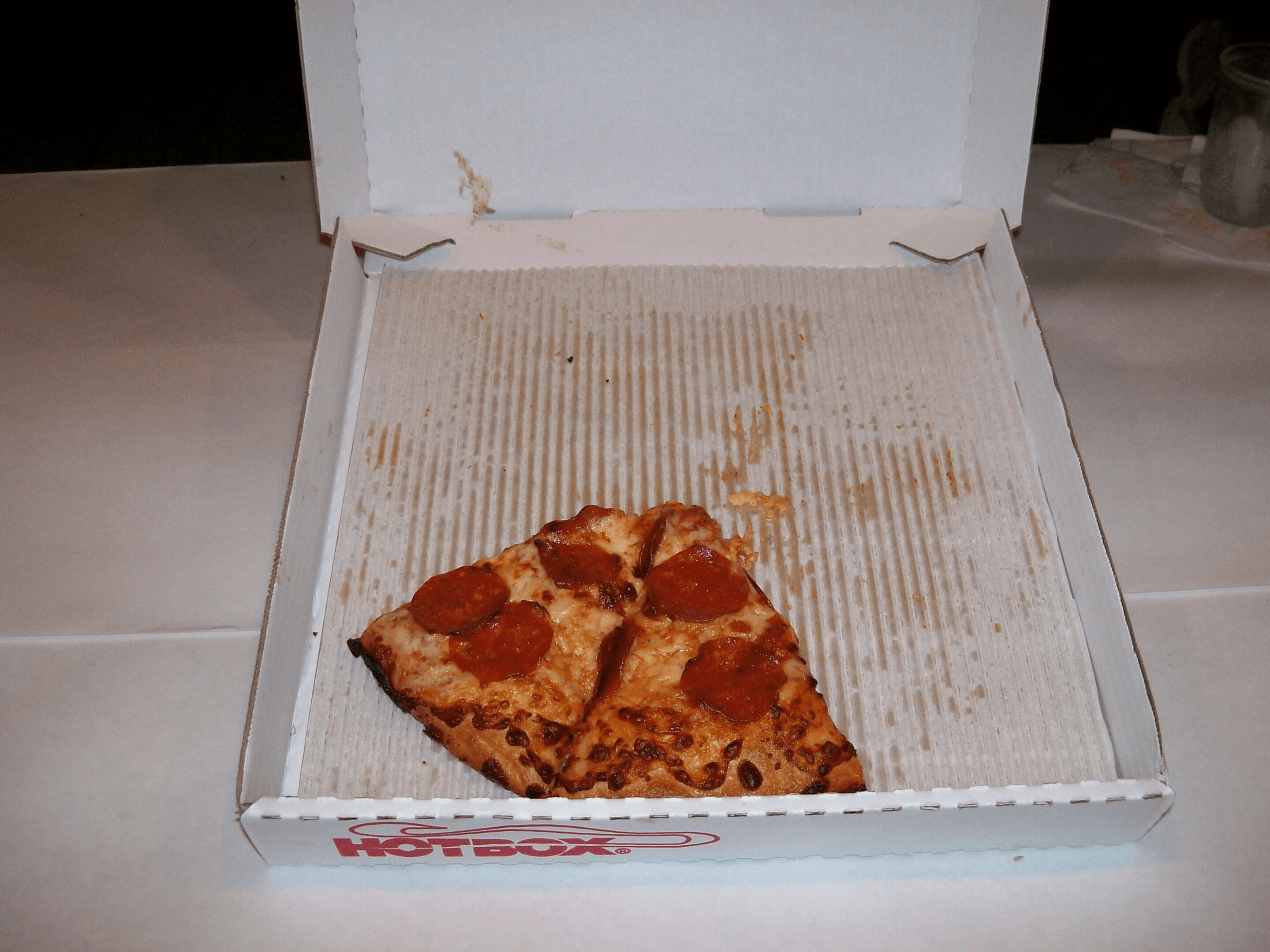 Pepperoni pizza slices in open box
