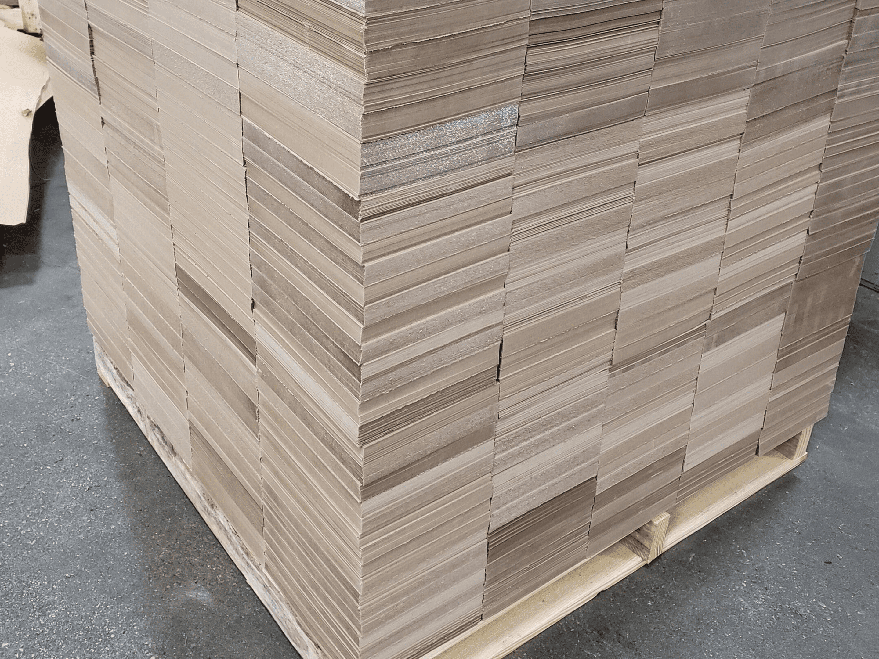 Stack of cardboard sheets on wooden pallet